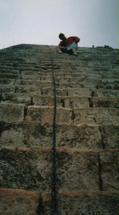 Fred bravely (huh!) descends staircase at Uxmal --
        "Look! No hands"